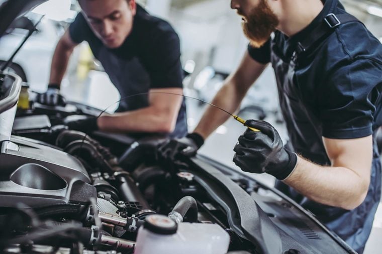 Auto technicians working on an engine